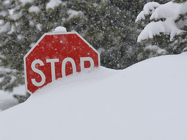 stop sign and large snow bank